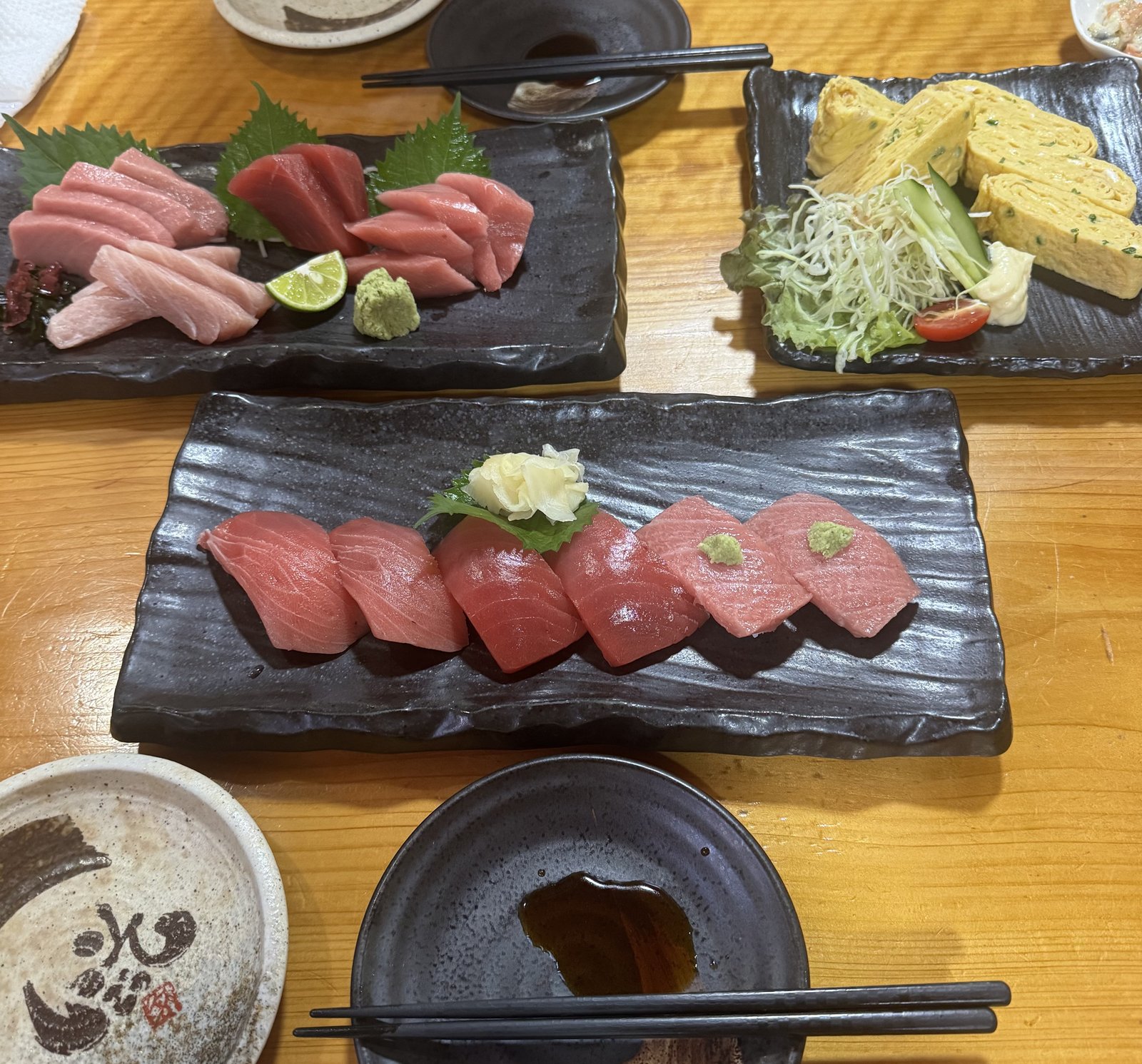 Assorted tuna sashimi platter and tamagoyaki at a local izakaya in Sukumo