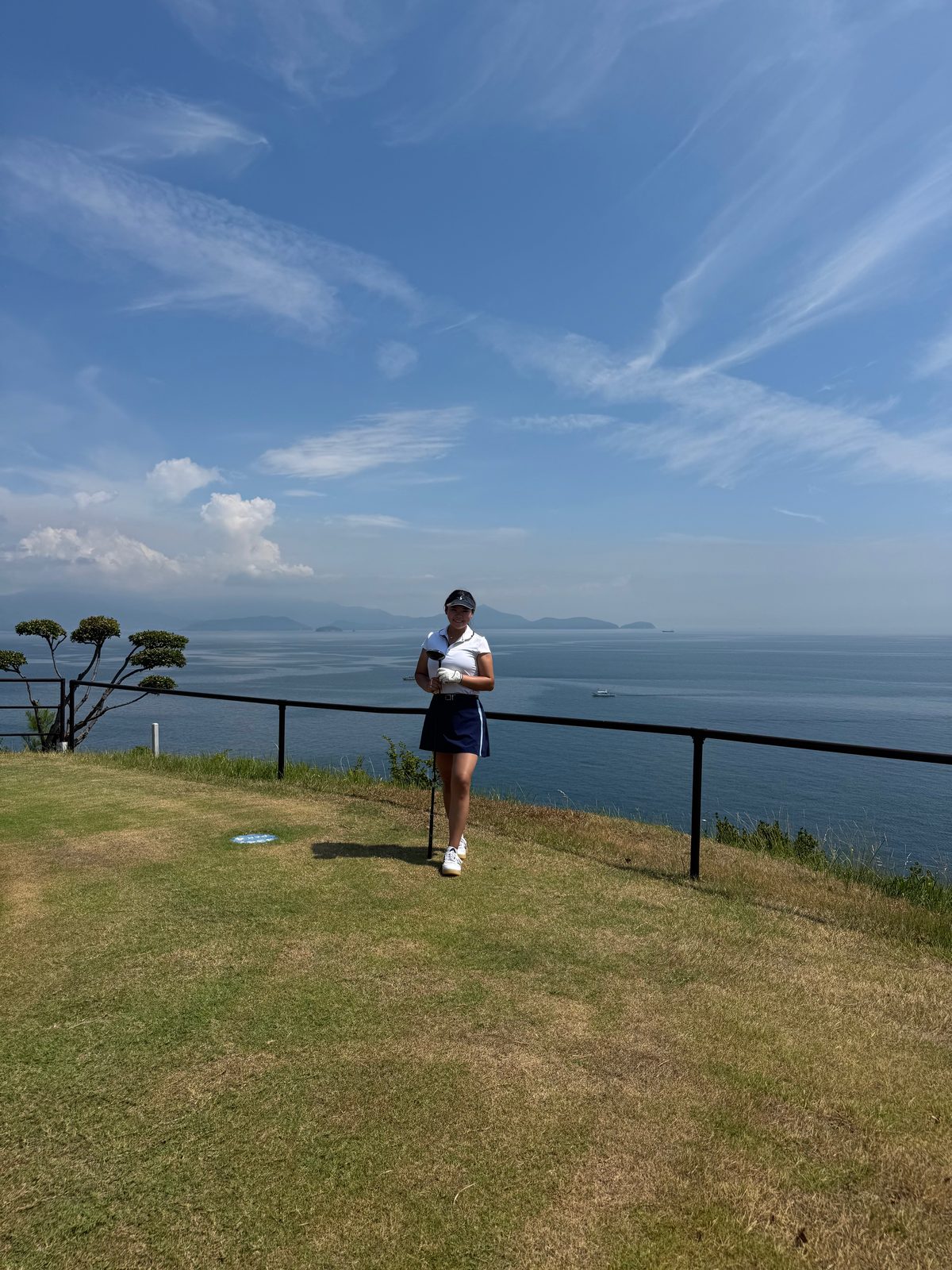 Golfer overlooking the Seto Inland Sea from a coastal course